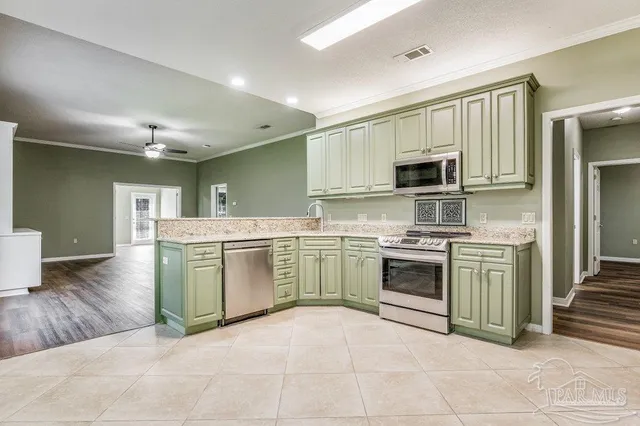 a kitchen with a sink a stove and cabinets