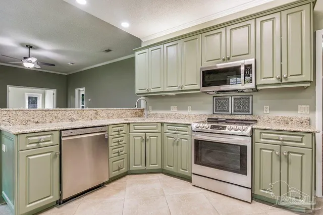 a kitchen with stainless steel appliances granite countertop a stove microwave and cabinets
