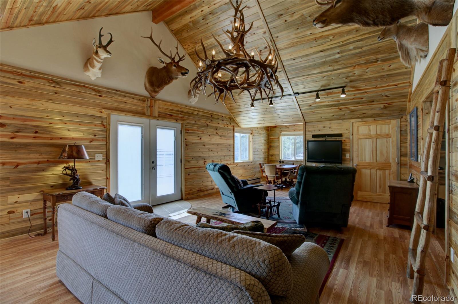 530 Red Feather Road Cotopaxi, CO 81223 - Photo 8 of 46 a living room with furniture and a wooden floor