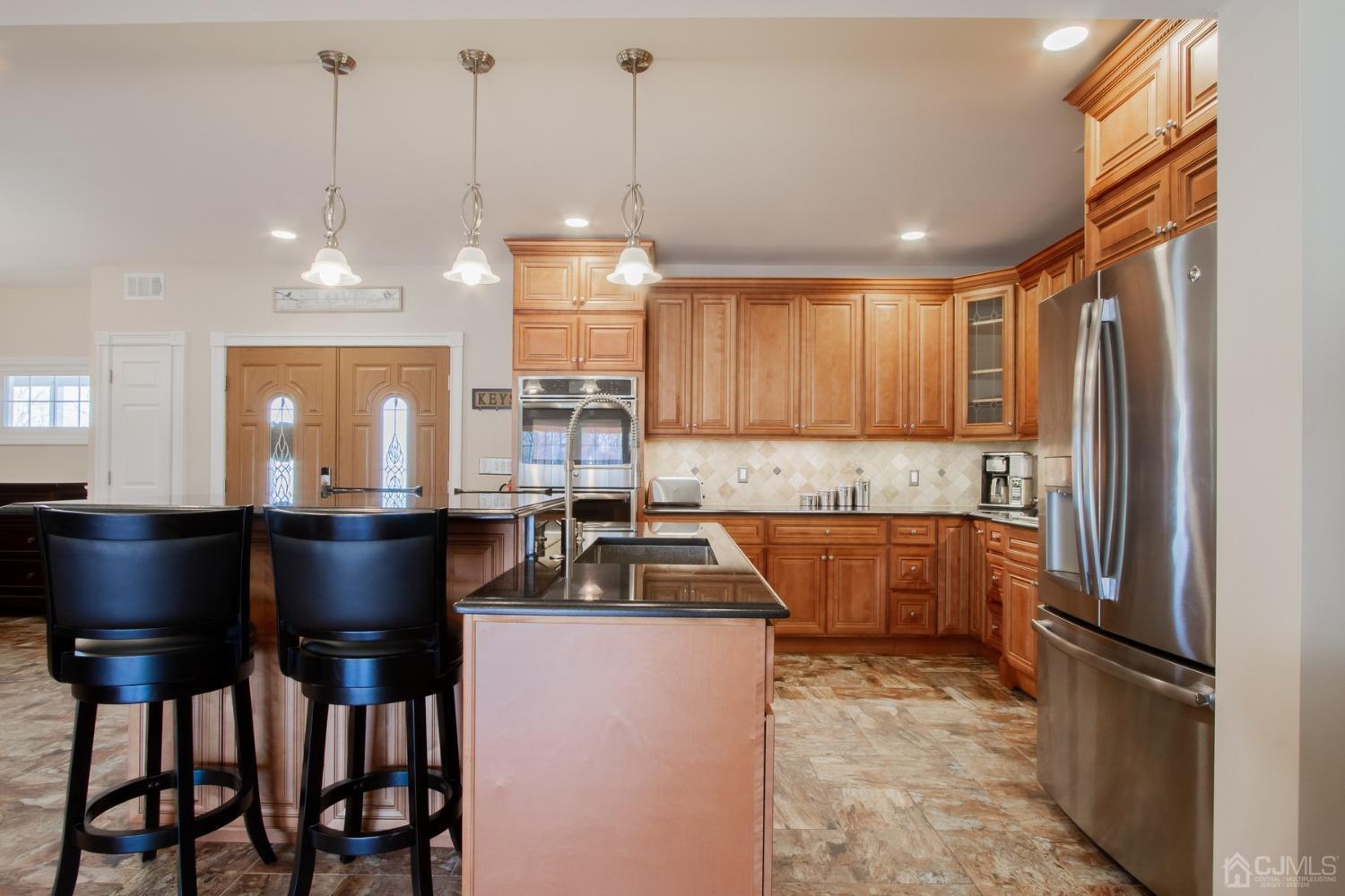 80 Princeton Road Old Bridge, NJ 08859 - Photo 15 of 40 a kitchen with granite countertop a refrigerator a sink dishwasher a stove and a dining table with wooden floor