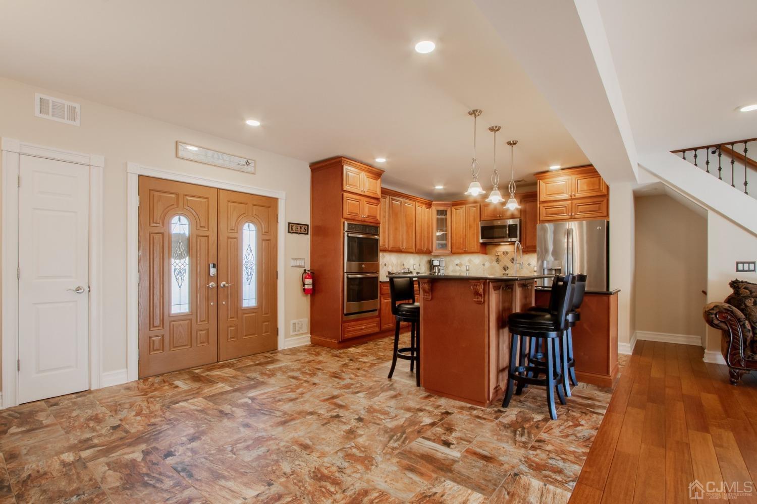 80 Princeton Road Old Bridge, NJ 08859 - Photo 5 of 40 a room with stainless steel appliances kitchen island granite countertop a refrigerator and a wooden cabinets