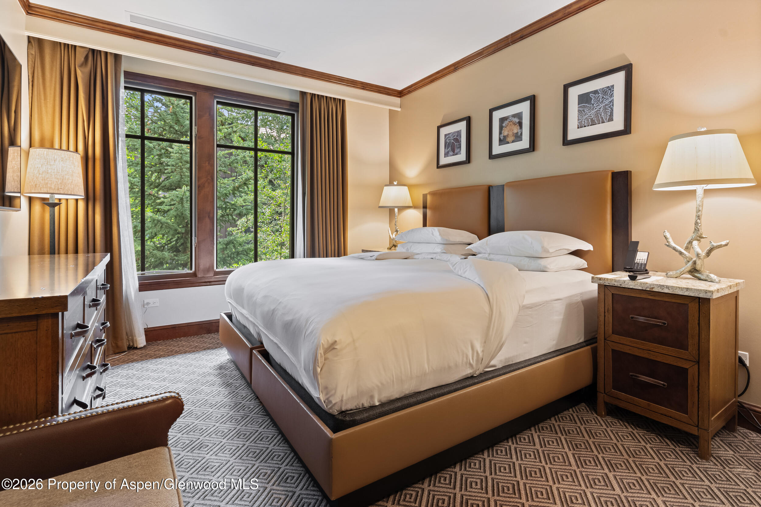 39 Boomerang Road, Unit 8210/WINTER INTEREST 3 Aspen, CO 81611 - Photo 16 of 44 a bedroom with a bed and wooden floor