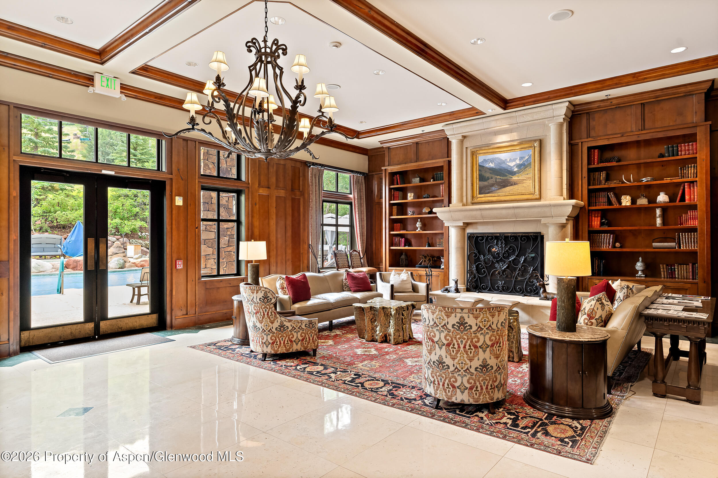 39 Boomerang Road, Unit 8210/WINTER INTEREST 3 Aspen, CO 81611 - Photo 21 of 44 a living room with furniture a fireplace and a chandelier