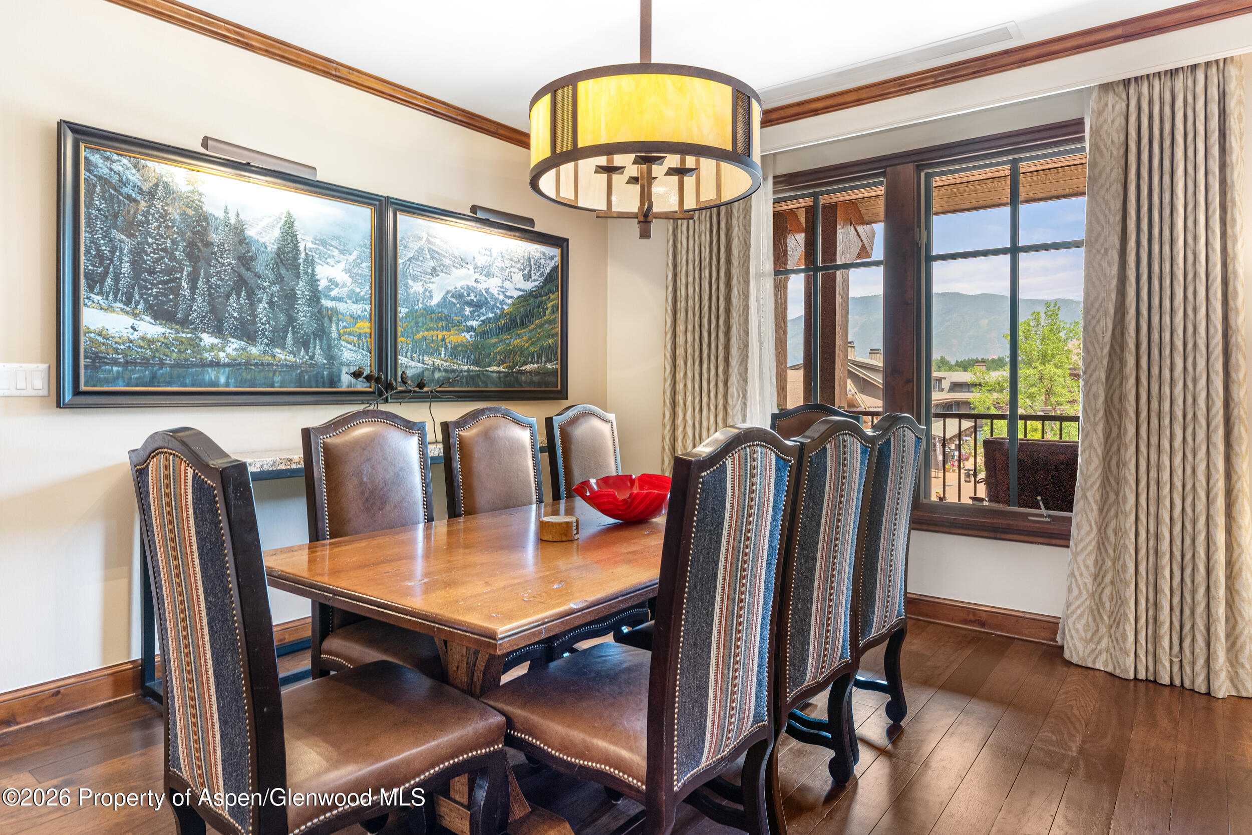 39 Boomerang Road, Unit 8210/WINTER INTEREST 3 Aspen, CO 81611 - Photo 7 of 44 a view of a dining room with furniture a chandelier and wooden floor