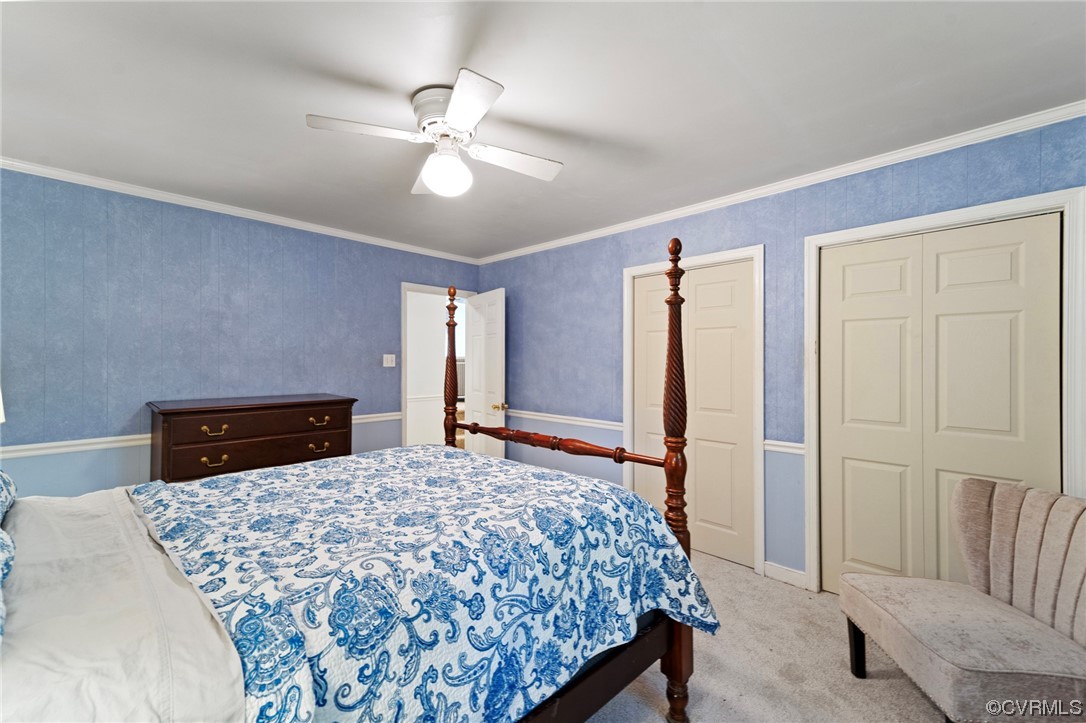1018 Ridge Top Road Henrico, VA 23229 - Photo 14 of 33 a bedroom with a large bed and a chandelier