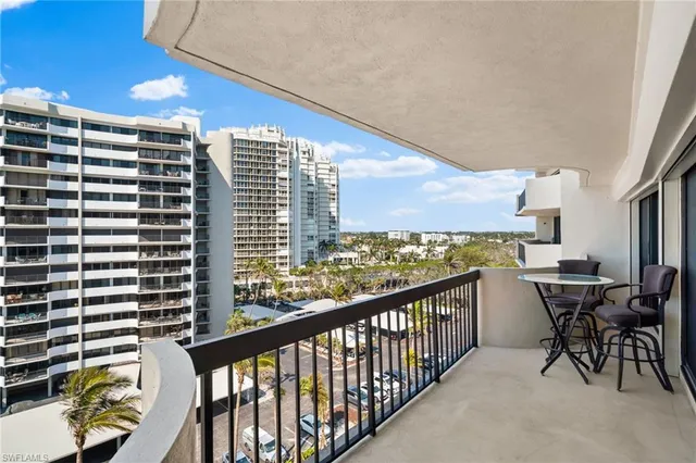a city view from a balcony with chairs