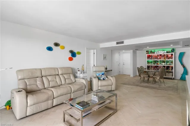 a living room with furniture and a book shelf
