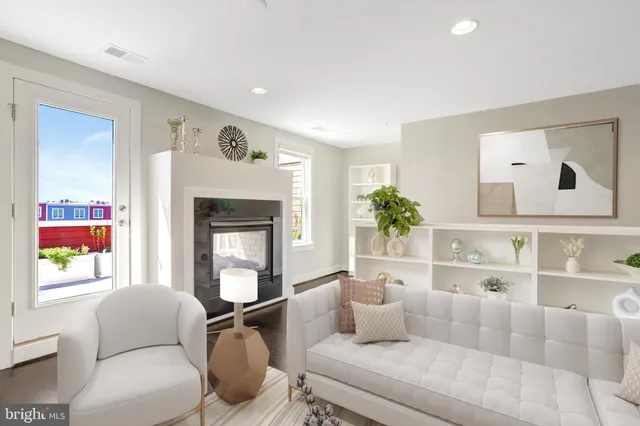 a roof deck with couches and potted plants