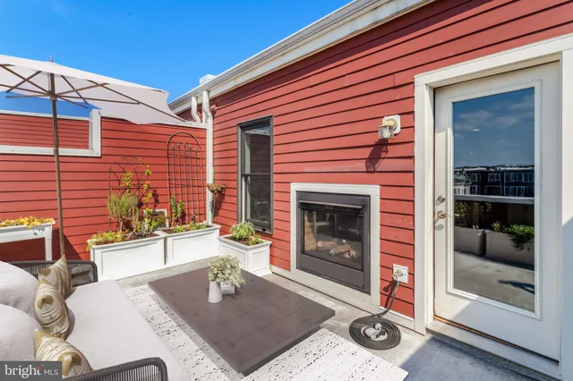a bathroom with a granite countertop sink a toilet and a shower