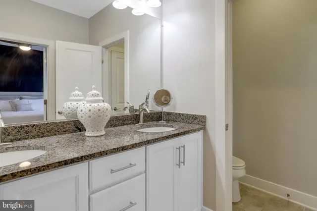 a bedroom with bed and a chandelier
