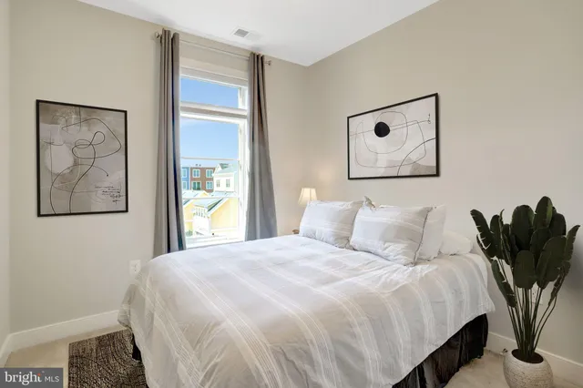 a bedroom with a bed and a painting on the wall