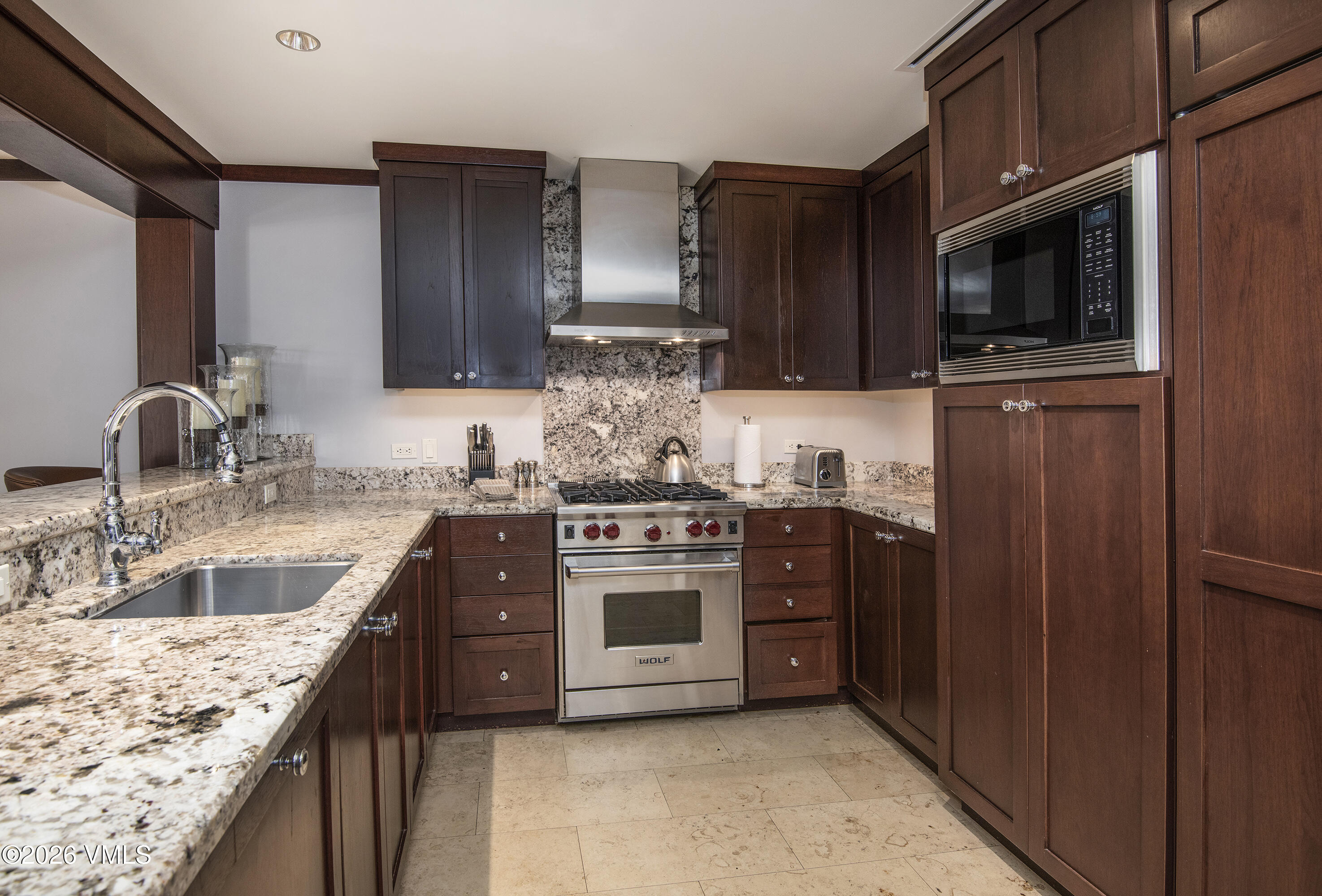 1 Vail Road, Unit 7105F Vail, CO 81657 - Photo 11 of 25 a kitchen with stainless steel appliances granite countertop a sink stove and microwave