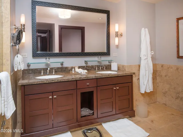 a bathroom with a double vanity sink and mirror