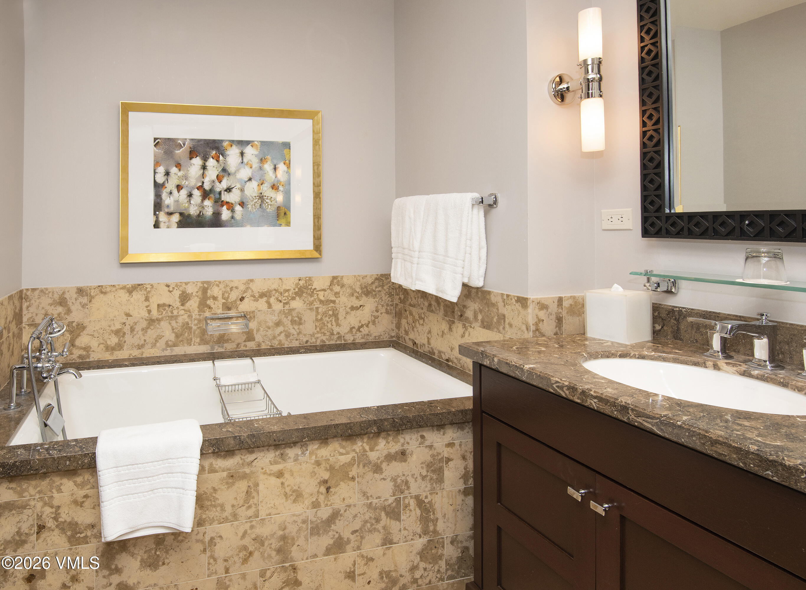 1 Vail Road, Unit 7105F Vail, CO 81657 - Photo 20 of 25 a bathroom with a granite countertop bathtub sink and mirror