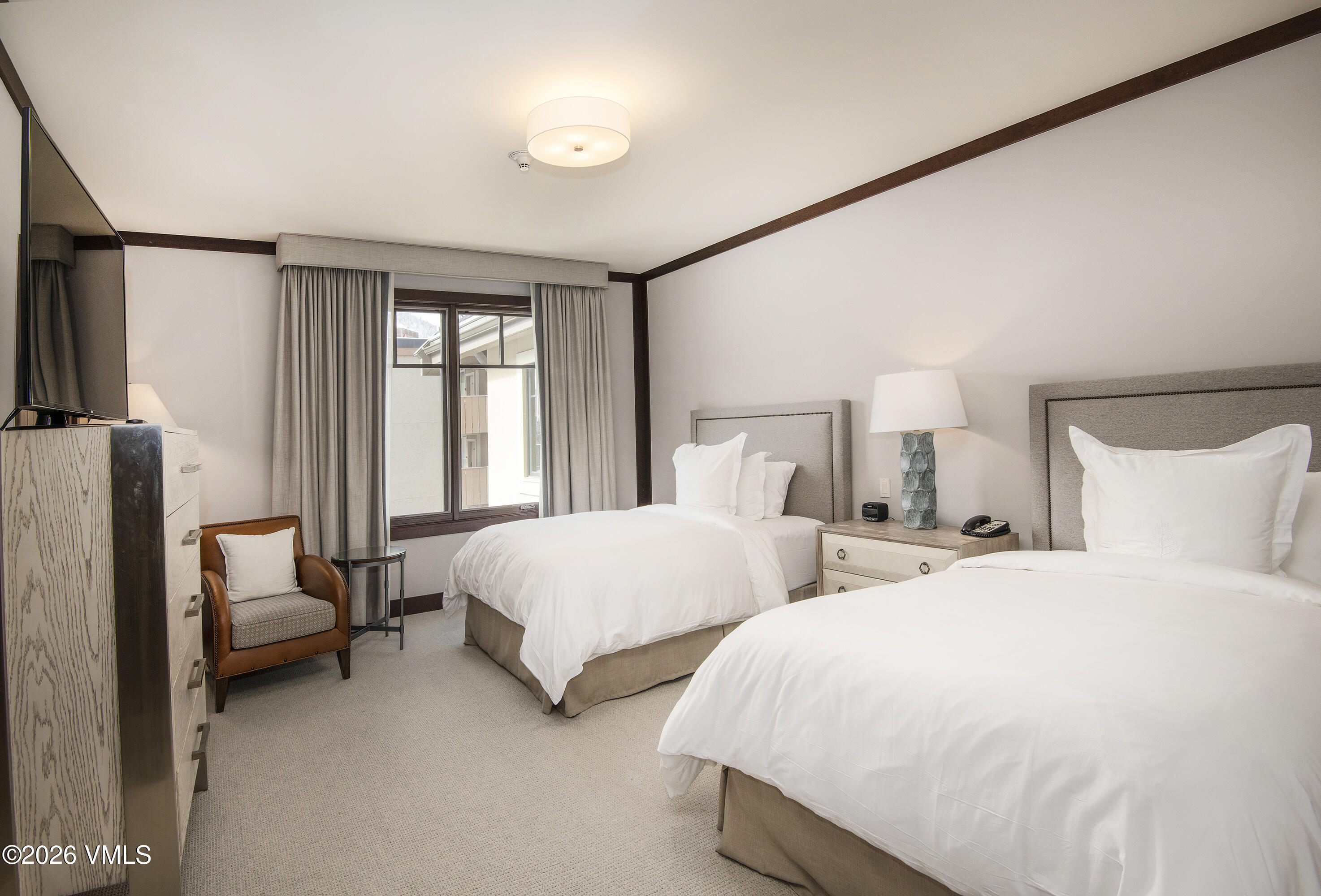 1 Vail Road, Unit 7105F Vail, CO 81657 - Photo 22 of 25 a bedroom with two beds and large window