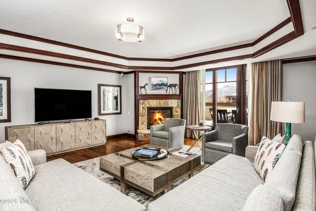 a living room with furniture a flat screen tv and a large window