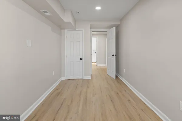 a view of hallway with wooden floor