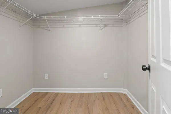 an empty room with chandelier fan