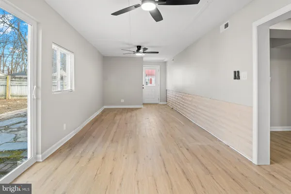 a bathroom with a granite countertop toilet sink and mirror