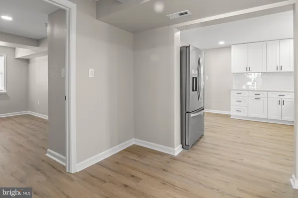 a view of a kitchen with wooden floor and electronic appliances