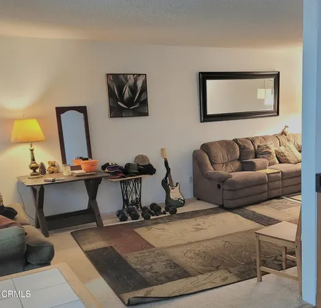 a living room with a couch and a dresser