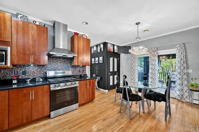 a kitchen with stainless steel appliances granite countertop wooden floors stove top oven and cabinets