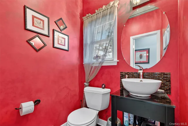 a bathroom with a sink mirror and toilet