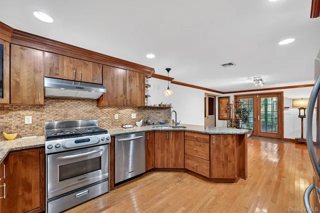 a kitchen with stainless steel appliances granite countertop a stove and a sink