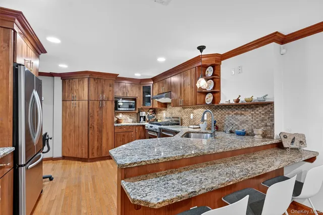 a kitchen with stainless steel appliances granite countertop a sink stove and refrigerator