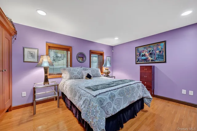 a bedroom with a bed and a dresser with rug