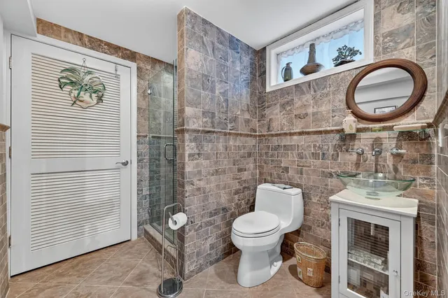 a white toilet sitting next to a bathroom sink