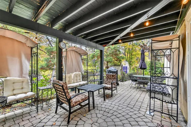 a building outdoor space with patio furniture and garden