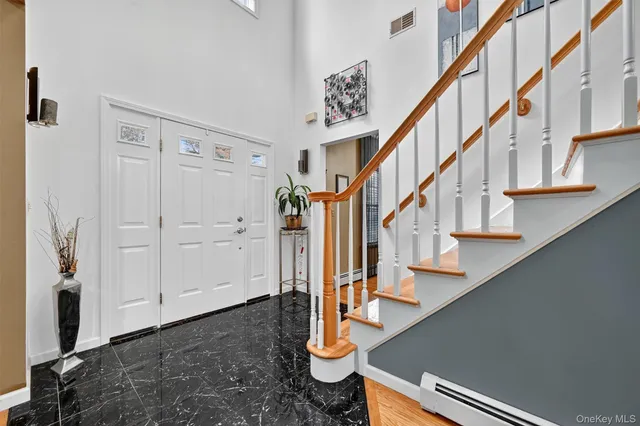 a view of staircase with lots of frames on wall