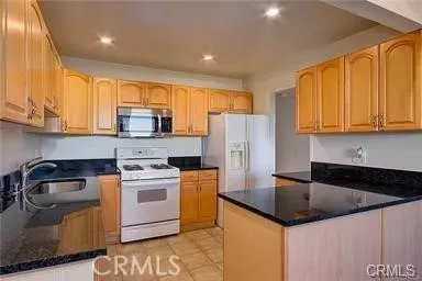 a kitchen with a sink a stove and cabinets