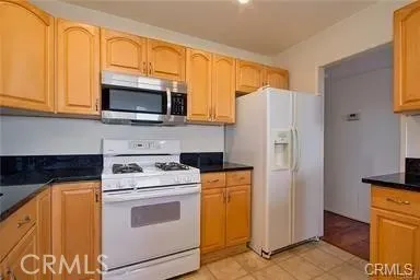 a kitchen with a stove microwave and refrigerator