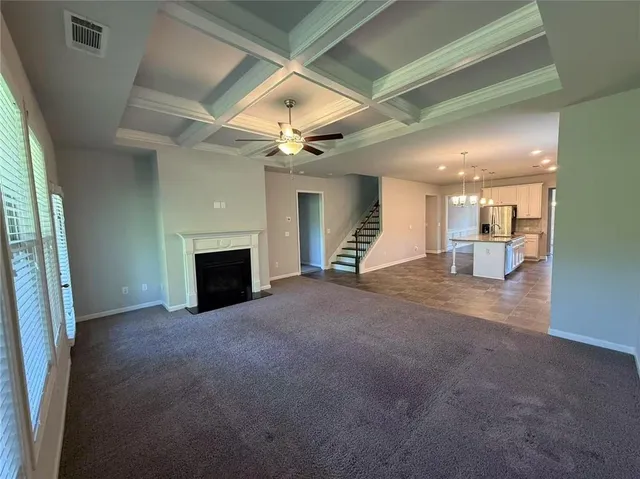 an empty room with furniture and a fireplace