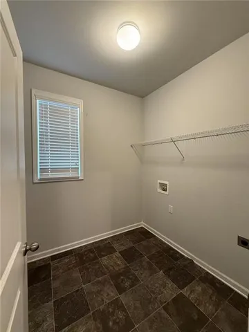 a view of a room with wooden floor and cabinets
