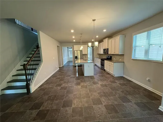 a view of a kitchen with stairs and entryway