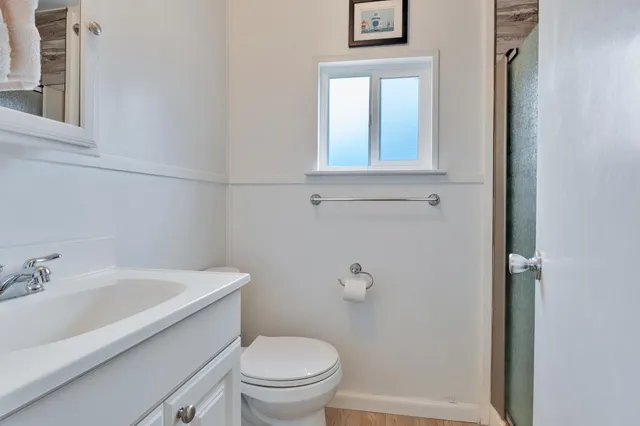 a white toilet sitting next to a bathroom sink