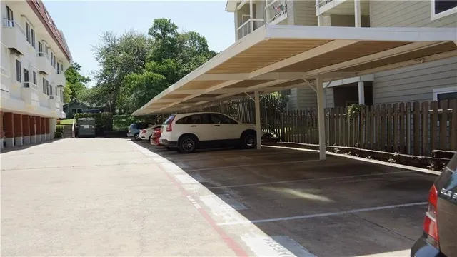 a white car parked in front of a building