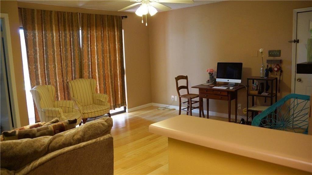 3115 Helms Street, Unit 304 Austin, TX 78705 - Photo 3 of 13 a living room with furniture and a flat screen tv