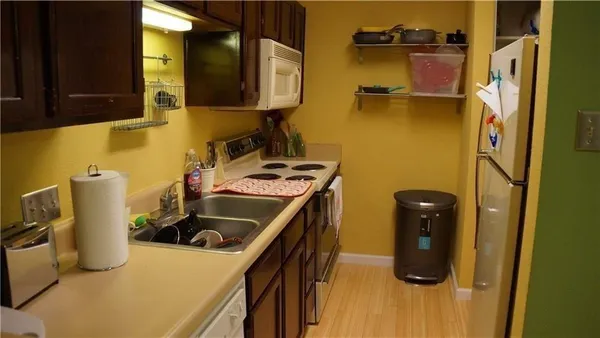 a kitchen with a sink and a refrigerator