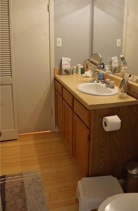 3115 Helms Street, Unit 304 Austin, TX 78705 - Photo 9 of 13 a bathroom with a sink toilet and mirror