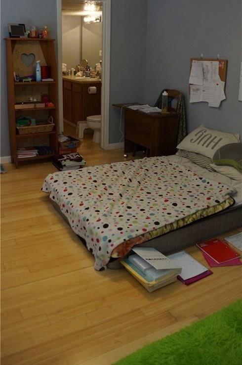 3115 Helms Street, Unit 304 Austin, TX 78705 - Photo 10 of 13 a bed sitting in a bedroom next to a window and dresser