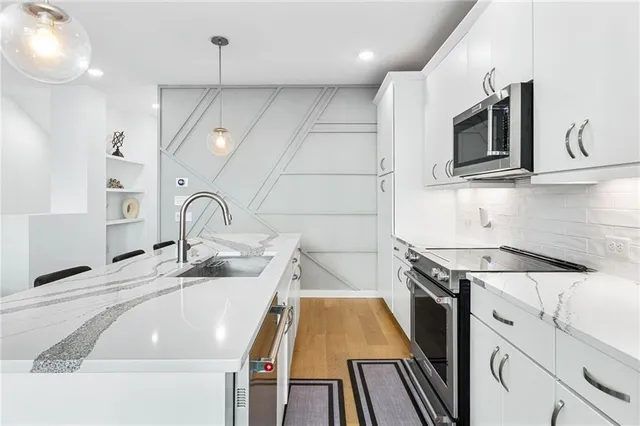 a kitchen with a sink a stove and microwave