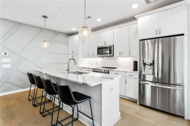 a kitchen with kitchen island appliances cabinets and furniture