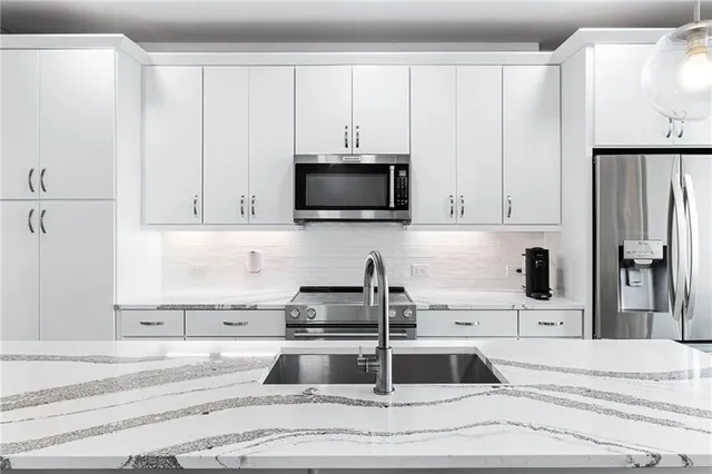 a view of a kitchen with a sink and cabinets