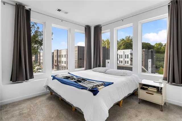 a bedroom with a bed and large window