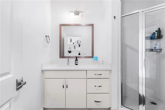 a bathroom with a bathtub sink vanity and mirror