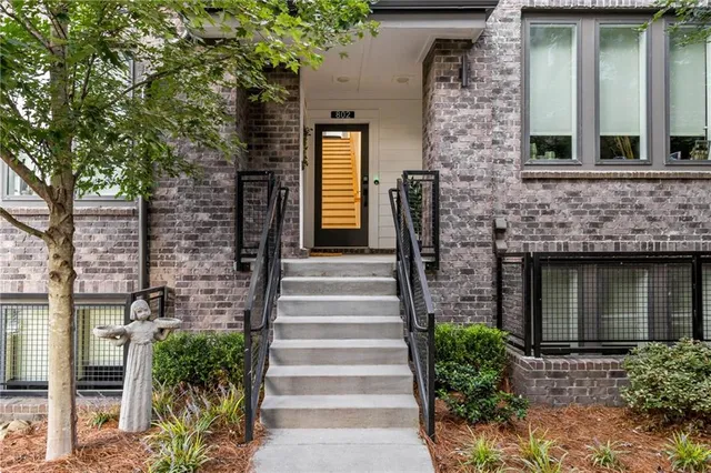 a front view of a house with plants